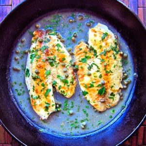 Tilapia piccata in a cast iron skillet