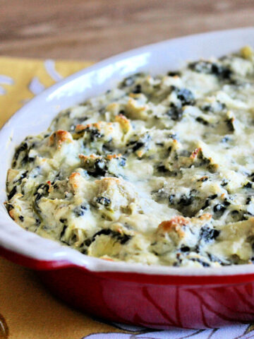 Healthy spinach artichoke dip in red casserole dish