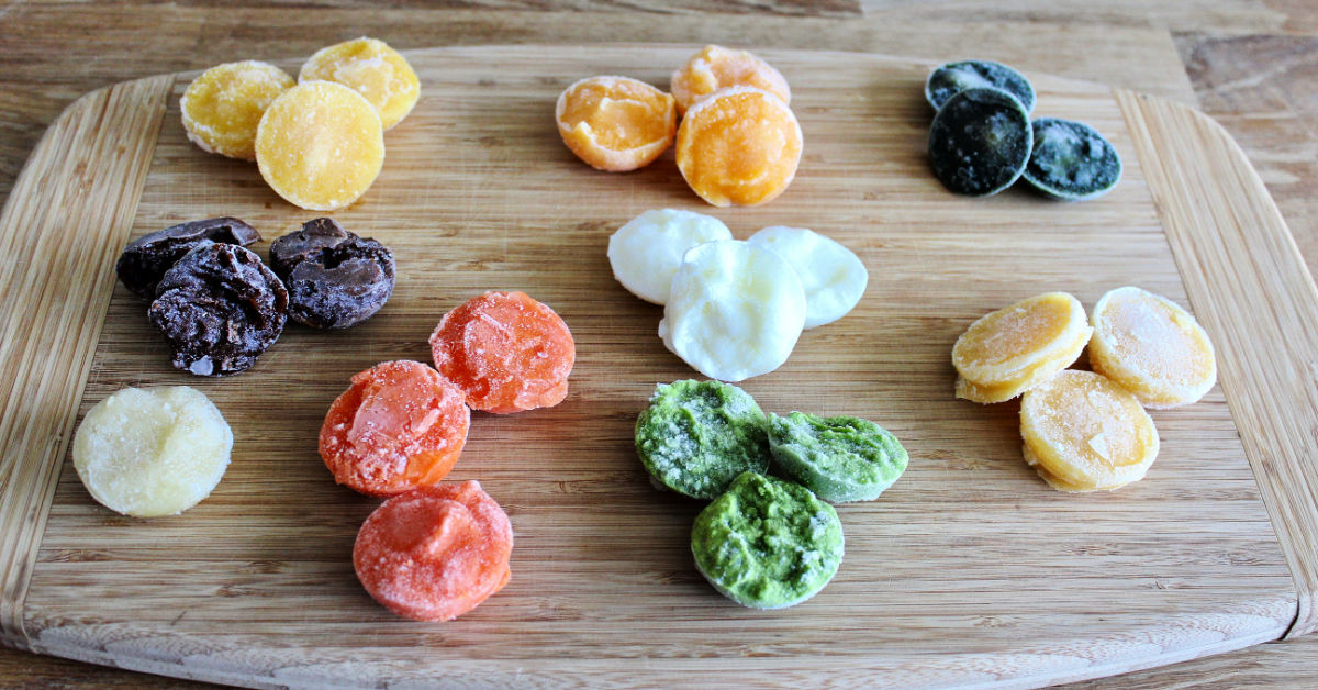 Piles of different flavors of frozen homemade baby food