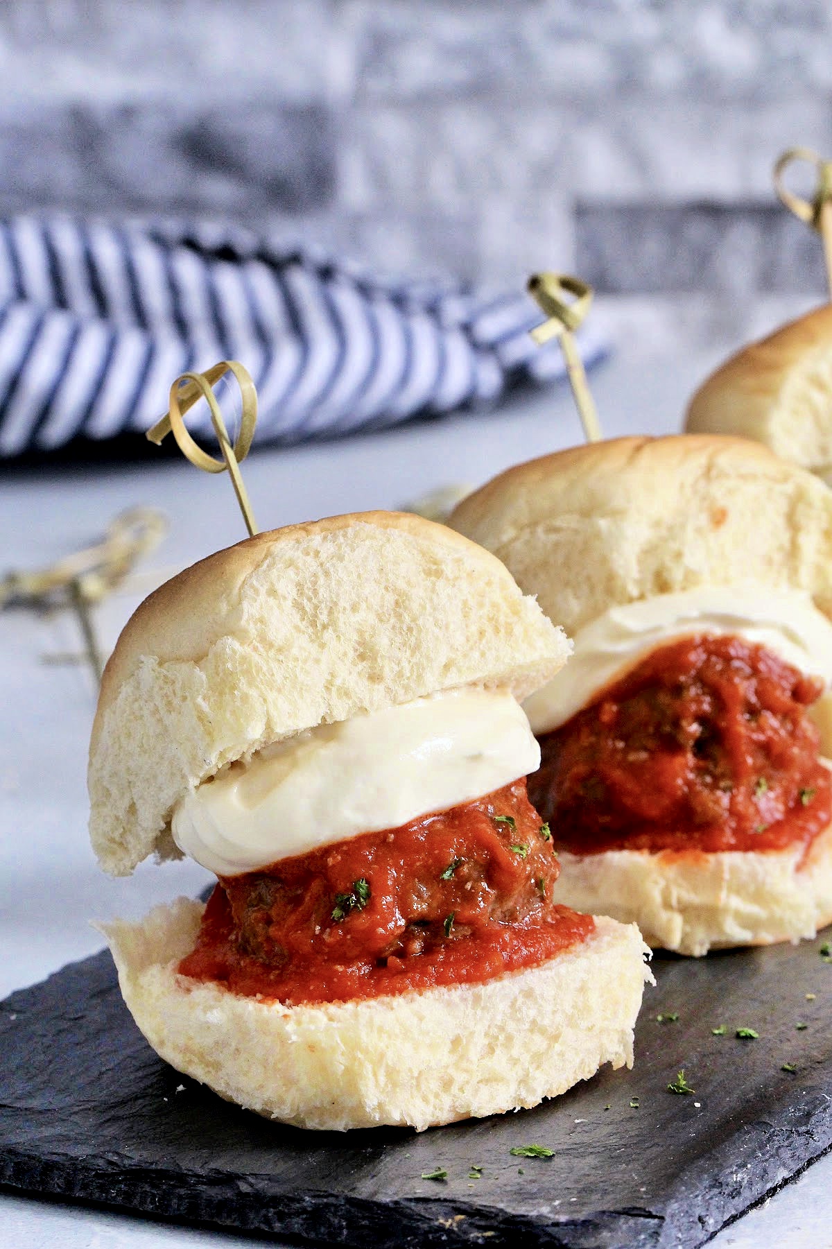 Row of meatball sliders with whipped ricotta