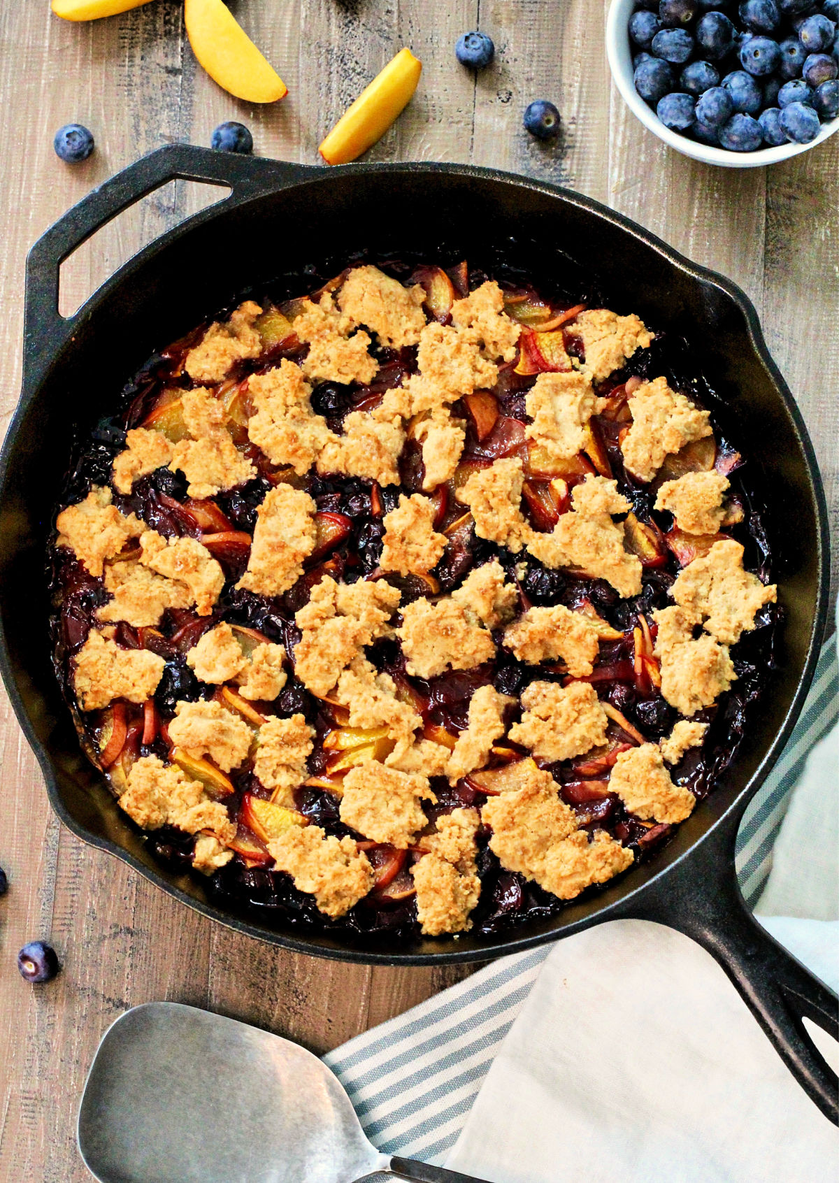 Overhead photo of Blueberry Peach Cobbler in a cast iron skillet. 
