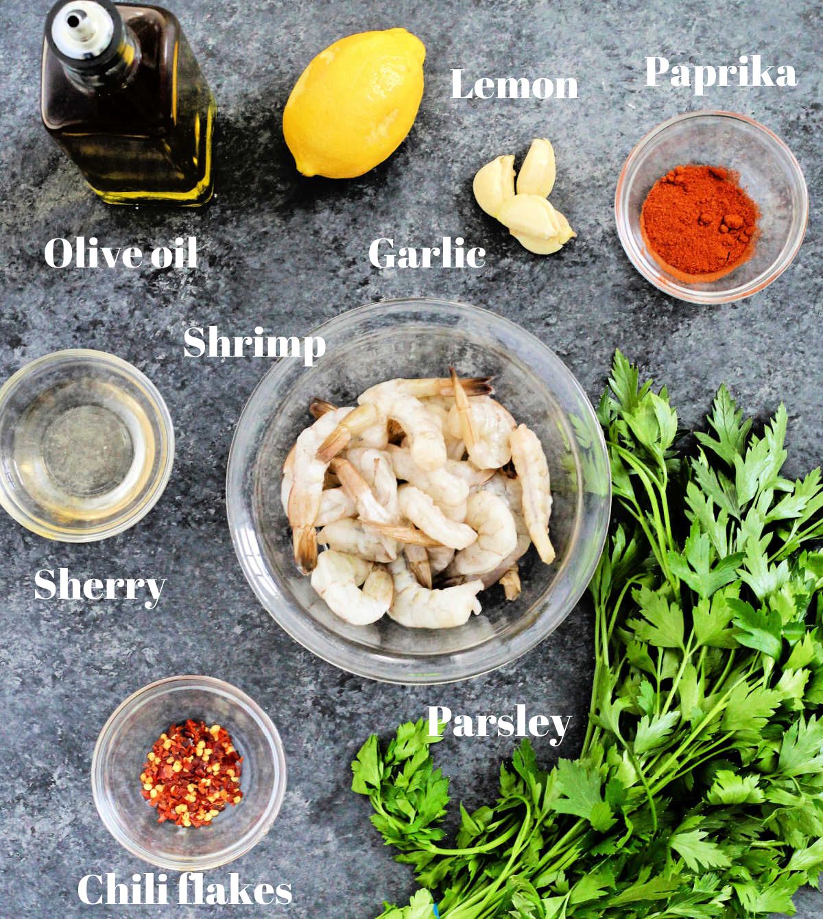 Ingredients for Spanish Garlic Shrimp on a gray board.