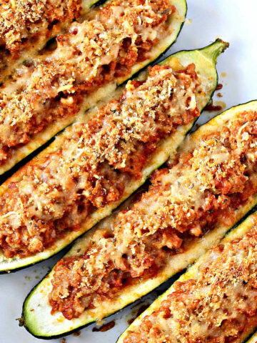 zucchini boats in a white baking tray.