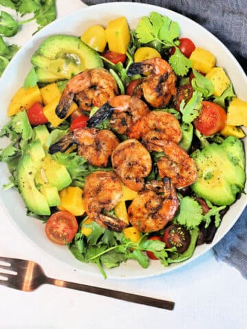 Grilled Shrimp Salad in a white bowl surrounded by a gray napkin