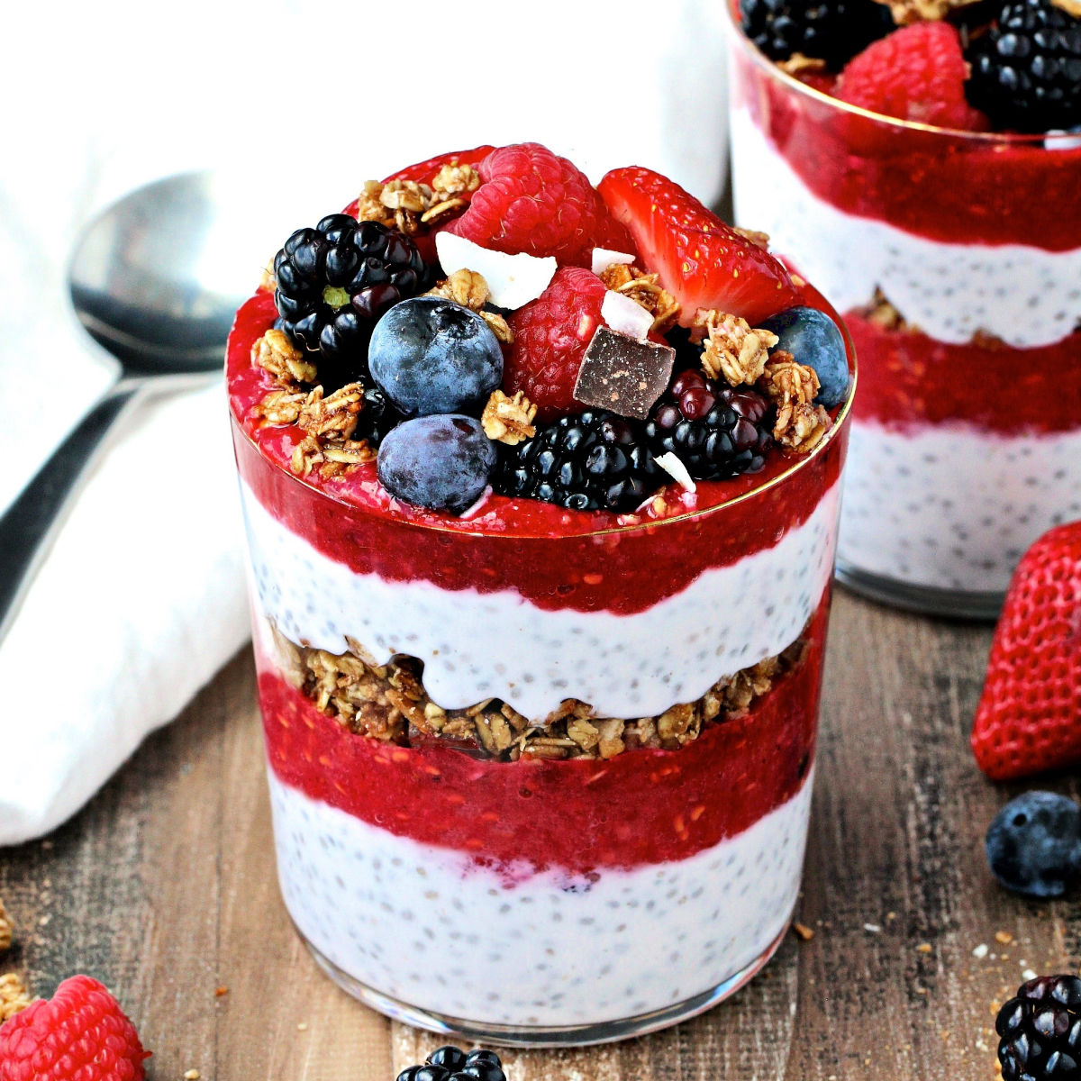chia pudding parfait in a glass topped with berries
