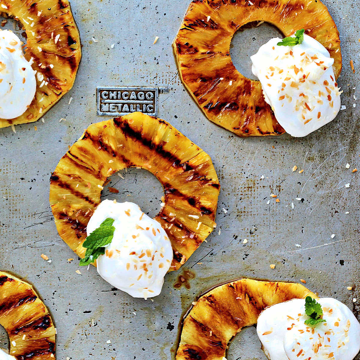 Grilled pineapple rings with aquafaba whipped cream.
