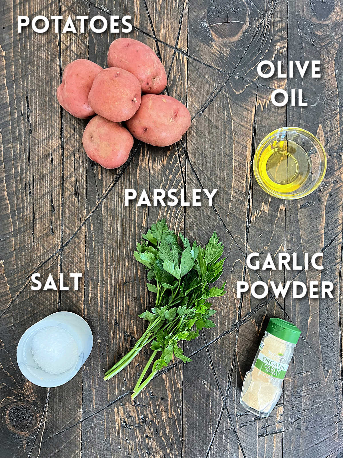 Ingredients for air fryer diced potatoes on a wooden board.
