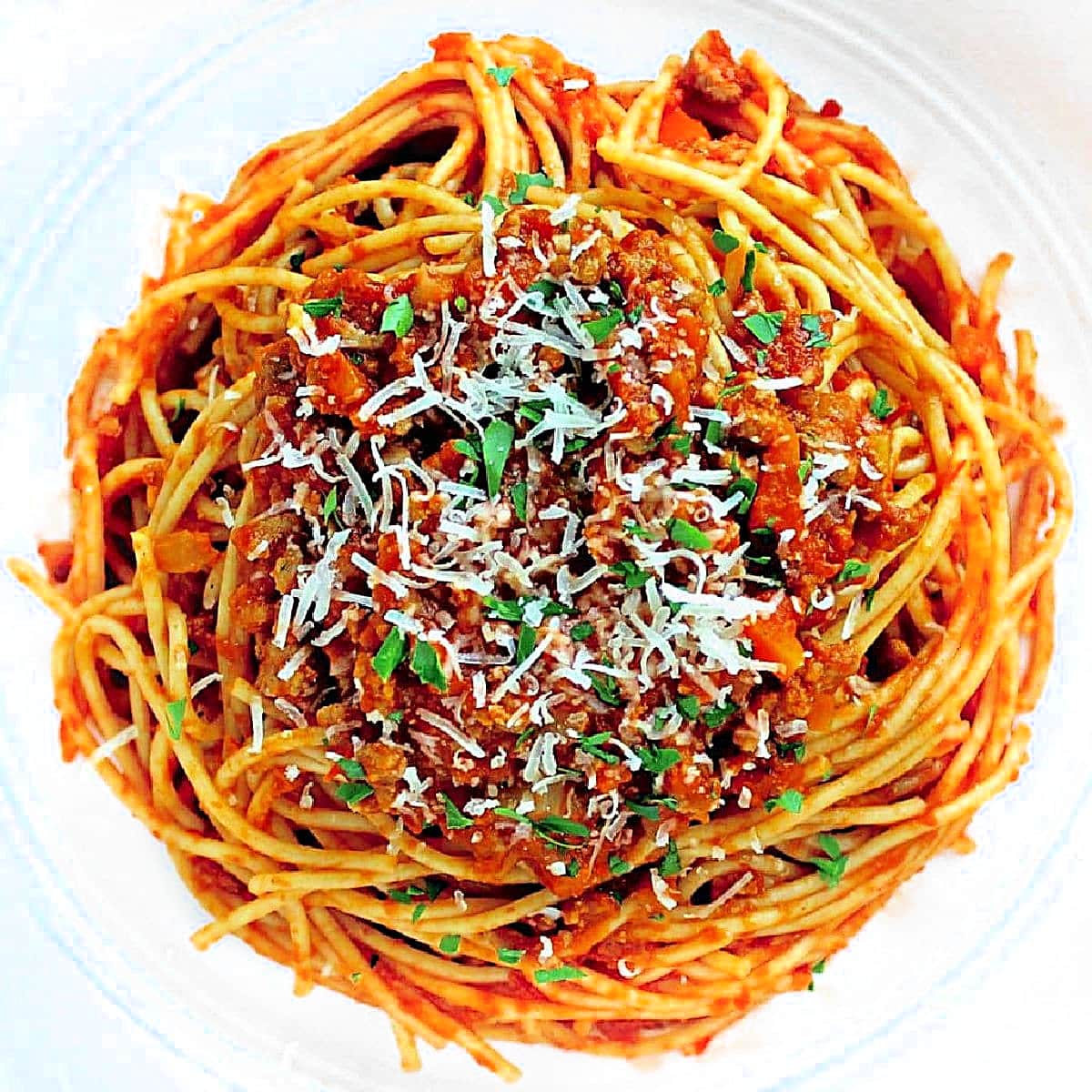 spaghetti bolognese in a white bowl.