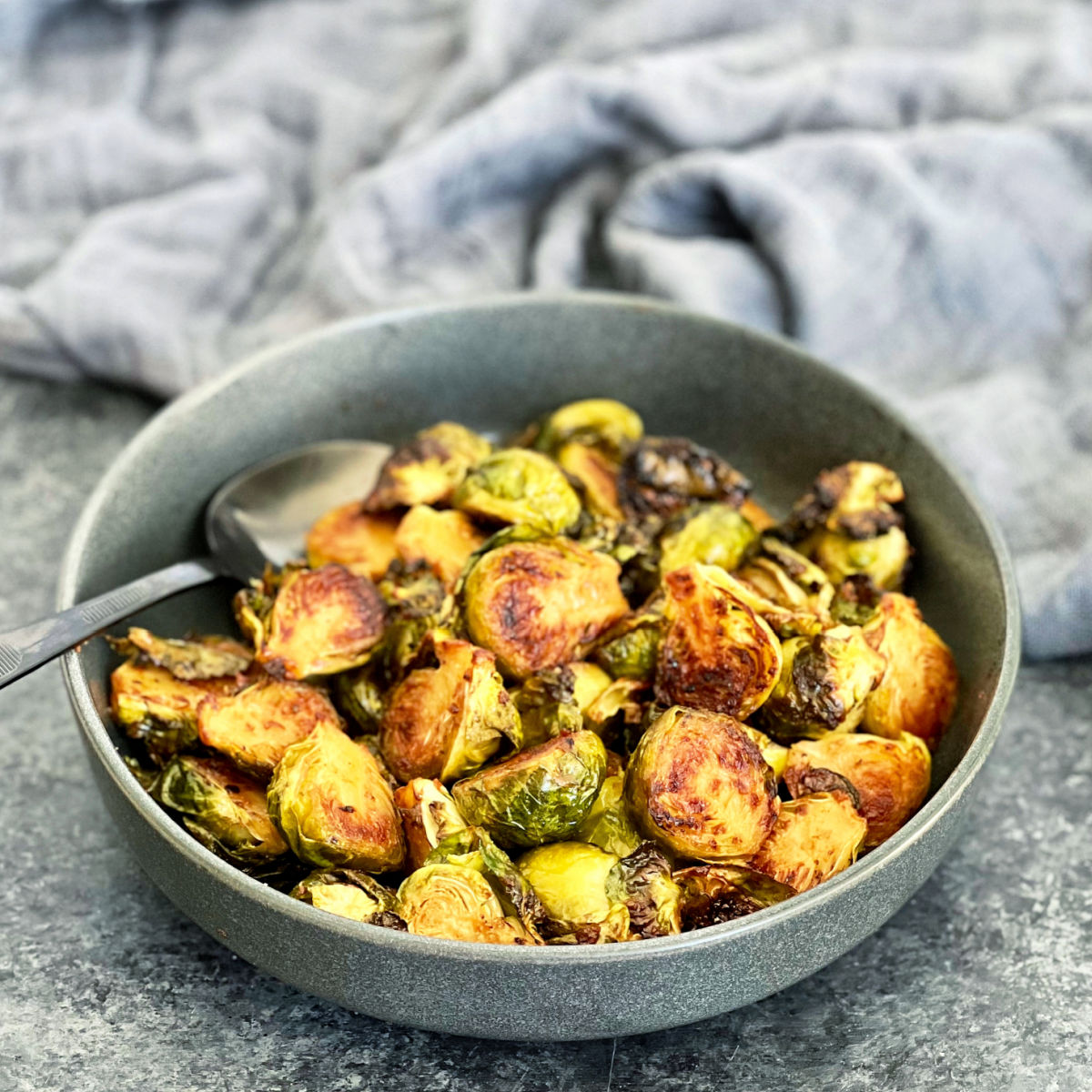 Miso roasted brussels in a gray bowl.