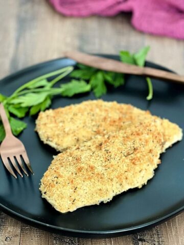 Crispy Baked Panko Chicken on a black plate.