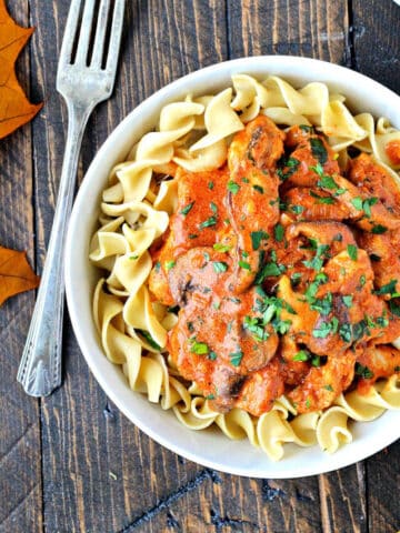Paprika chicken in a bowl with egg noodles.