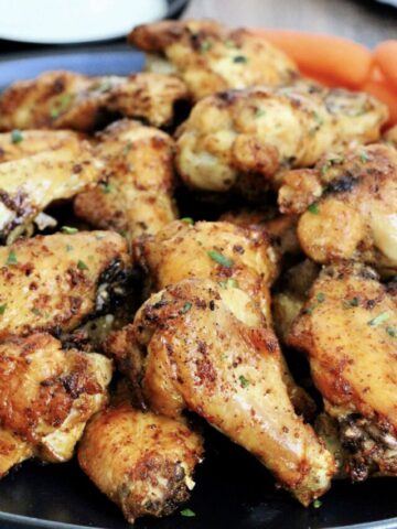 Pile of air fryer chicken wings on black plate