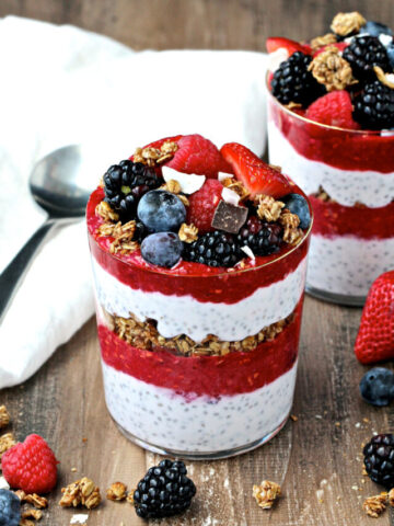Chia pudding parfaits on a brown board.