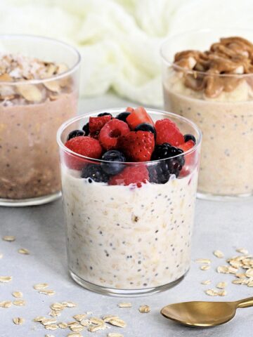 3 cups of protein overnight oats with different toppings.