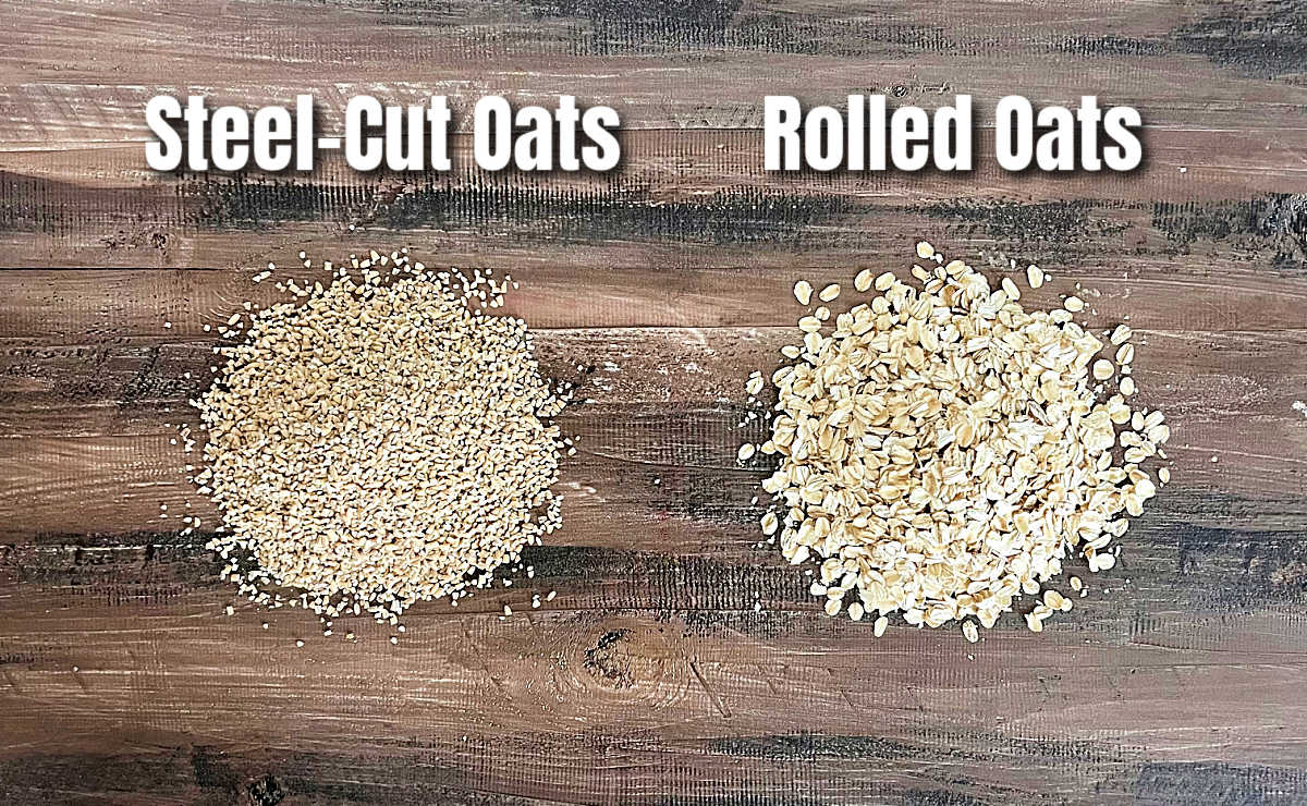 Piles of steel-cut oats and rolled oats next to each other on a wooden board.