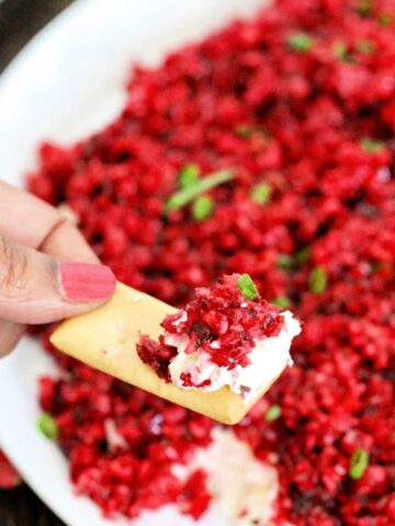 Scoop of cranberry jalapeno dip on a cracker